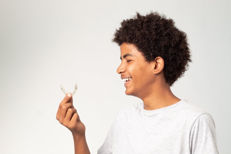 Teen is pleased with Invisalign clear aligner